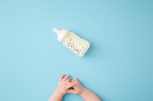 baby hands and baby bottle